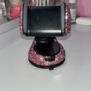 Pink bedazzled phone holder for car.